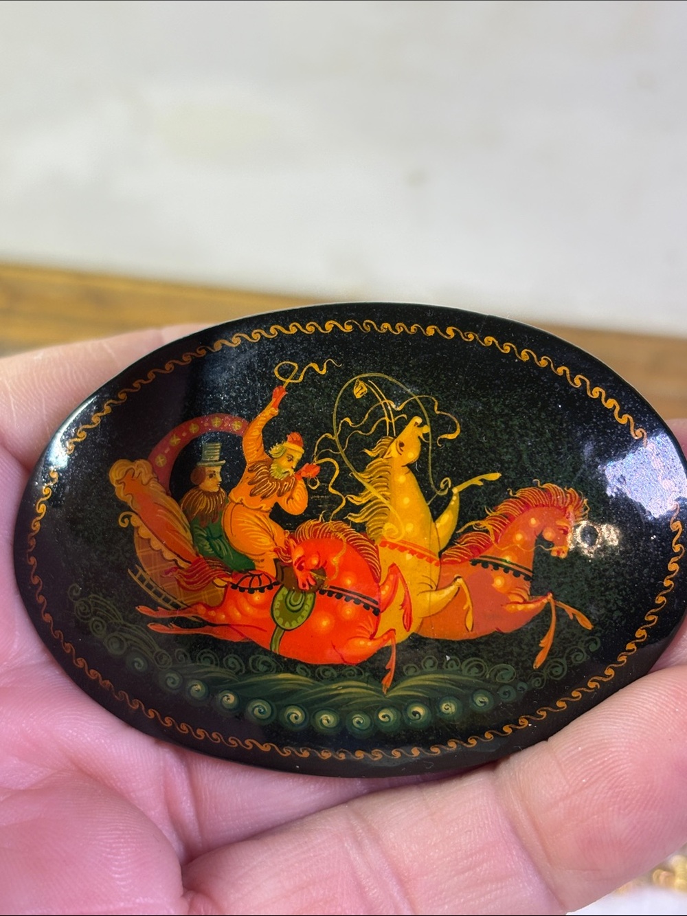 Wooden lacquered brooch with horses
